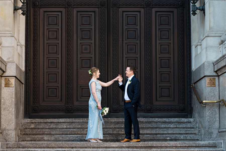 A groom asking his bride to dance on the city steps in Philly.